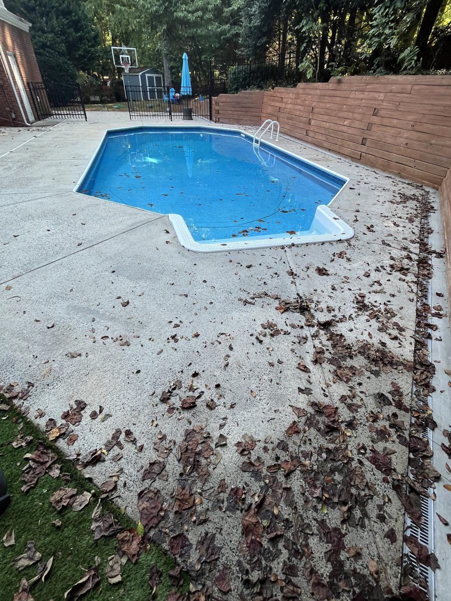 Cracked, stained pool deck before resurfacing